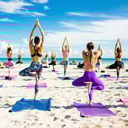 people doing beach yoga